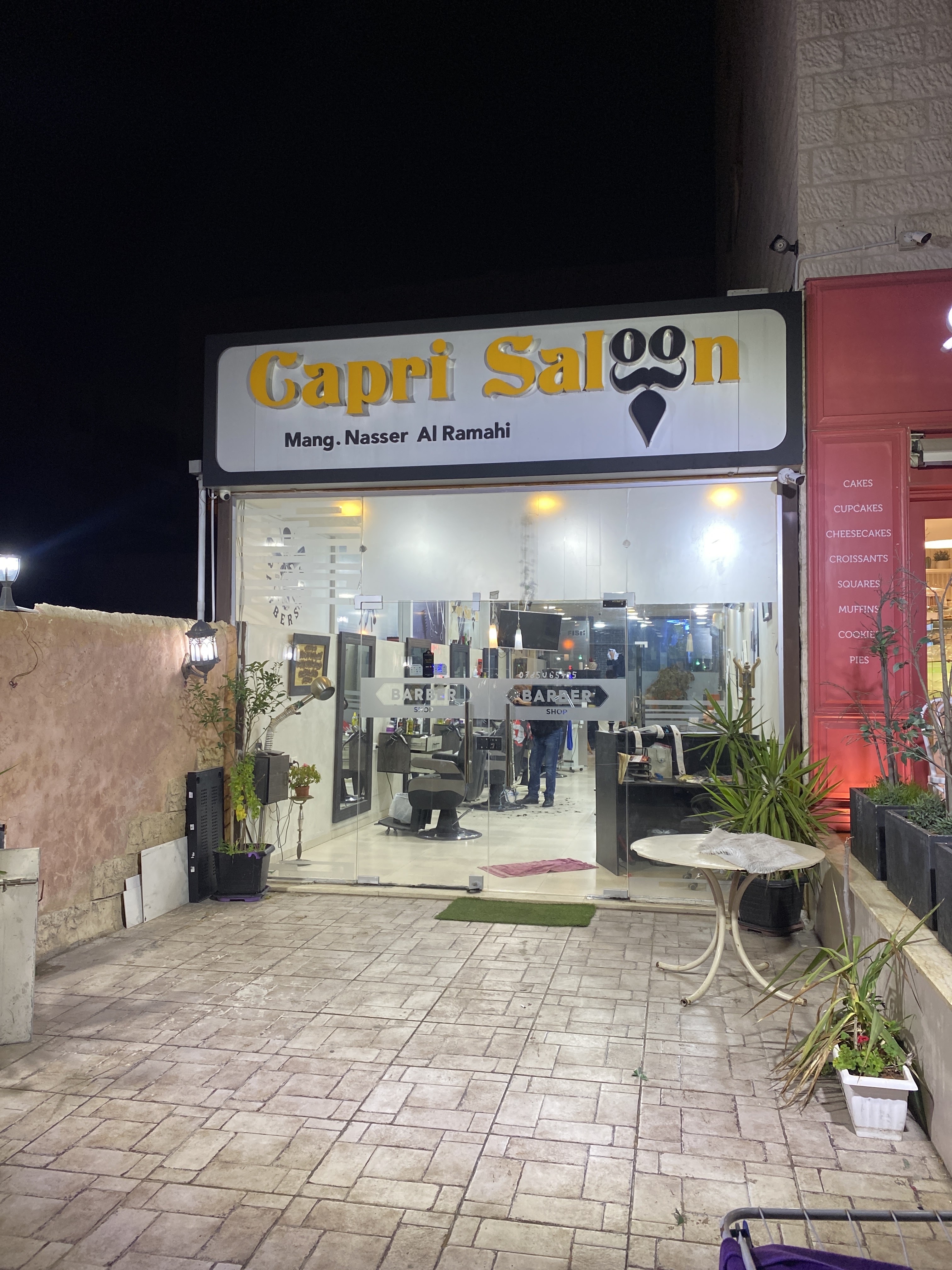 Capri Saloon storefront lit up at night