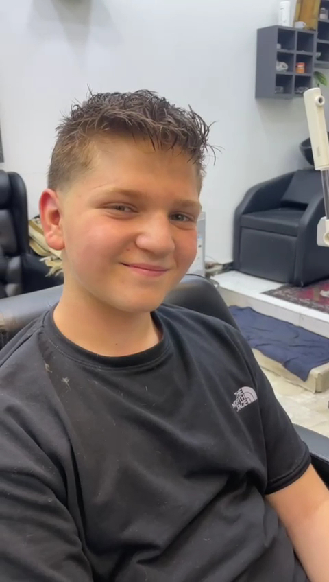 Young client smiling with a fresh haircut